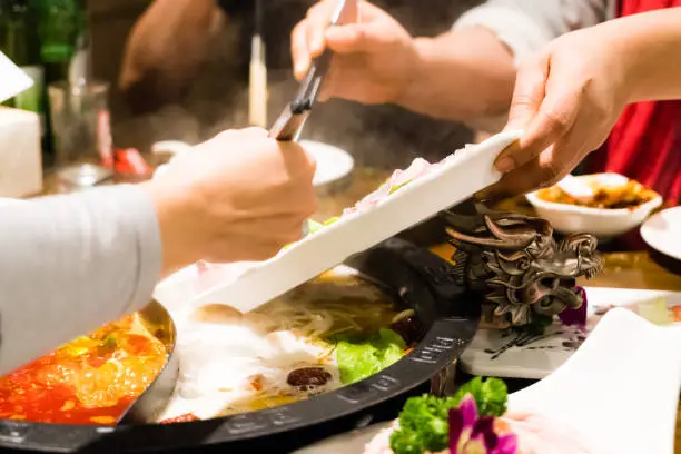 Two women are cooking the Chinese shabu hotpot