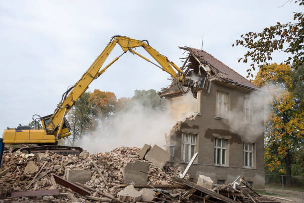 digger demolishing houses stock photo
