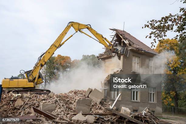 Digger Demolishing Houses Stock Photo - Download Image Now - Demolishing, House, Demolished