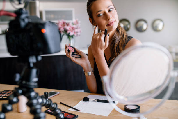 istock Young female vlogger recording a make-up video for her vlog. 673683284
