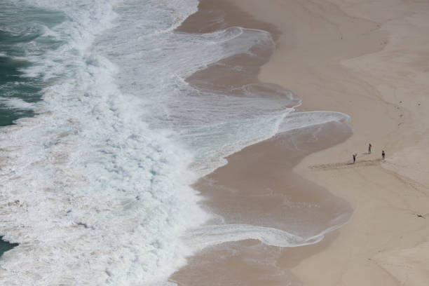 istock Giant Waves Crashing Down on White Sand Beach 673687426
