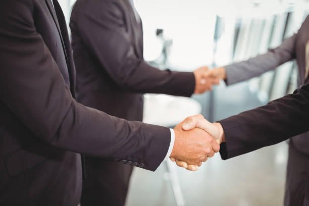 istock Businesspeople shaking hands with each other 673690986
