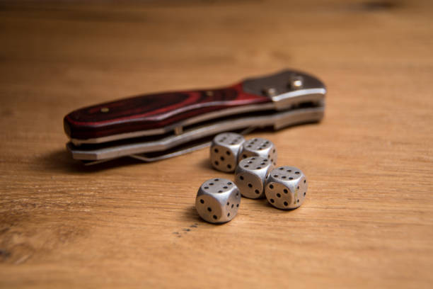 istock Gambling dice and  jump knife 673691870