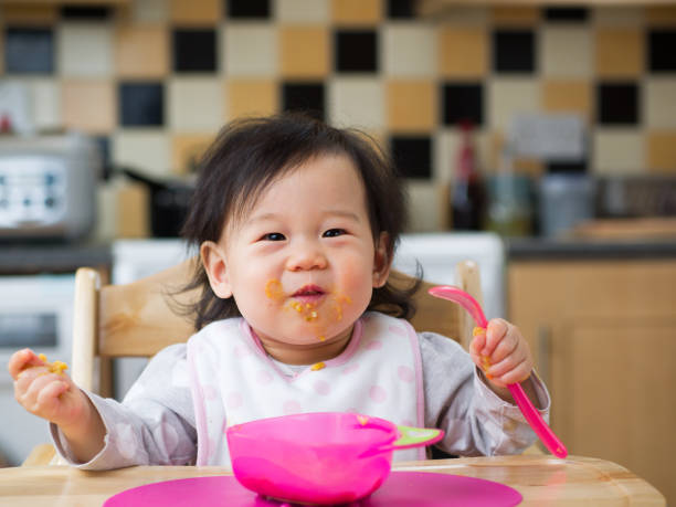 istock eating mess baby girl 673700380