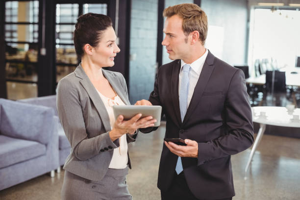 istock Businessman and businesswoman using digital tablet 673701224