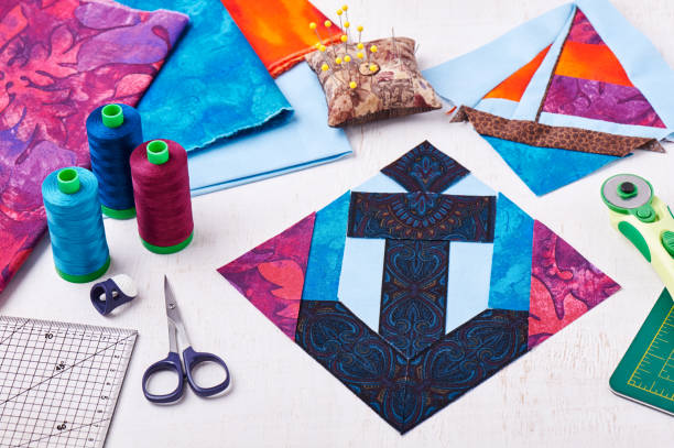 istock Sewing patchwork of block anchor surrounded by accessories 673710160