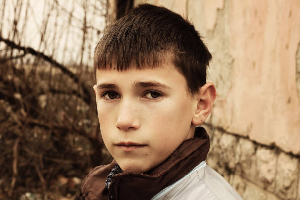 istock Sad young boy standing on abandoned place 673713762