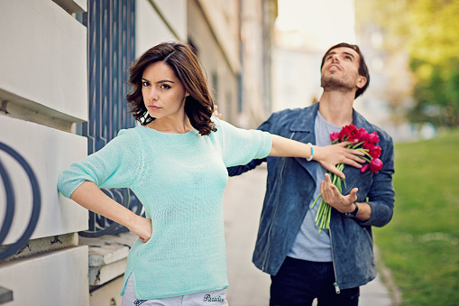 Young is girl is rejecting boy on the street