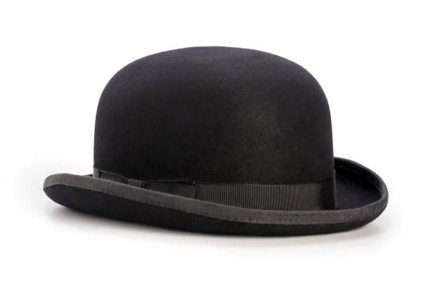 Black bowler hat isolated on a white background This is a photograph taken in the studio of a black bowler hat sitting on a white background. There is a drop shadow included with this file and there are no people in the shot bowler hat stock pictures, royalty-free photos & images