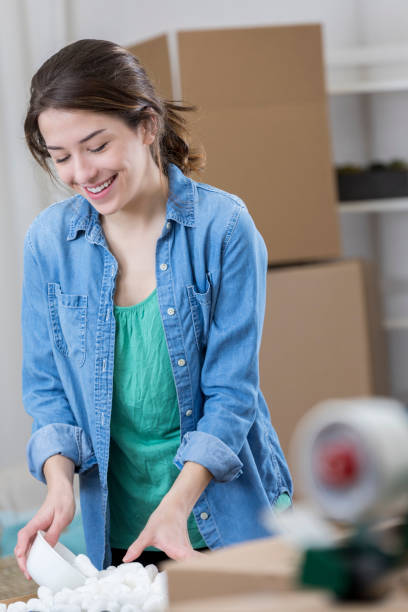 istock Confident woman packs up kitchen in her home 673719614