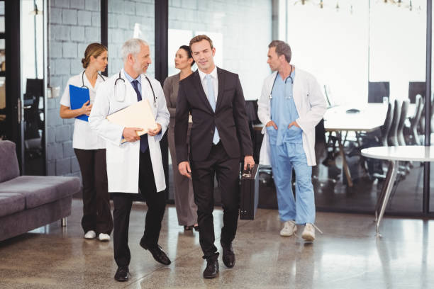 istock Medical team interacting each other while walking together 673723360