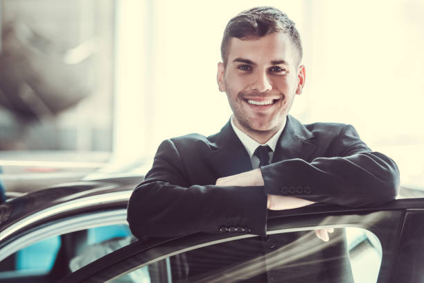 istock Handsome businessman with car 673723480
