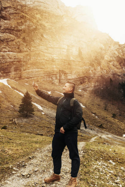 istock young hiker taking a selfie in front of mountains 673726614