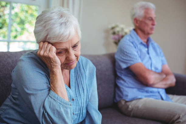 istock Thoughtful senior woman sitting on sofa 673726684