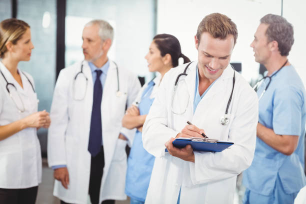 istock Male doctor writing on clipboard 673726762