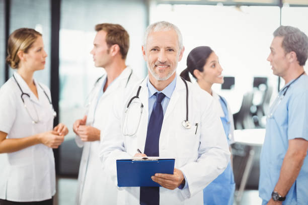 istock Male doctor writing on clipboard 673726792