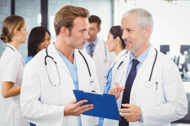 istock Two doctors looking at clipboard and discussing in hospital 673728930