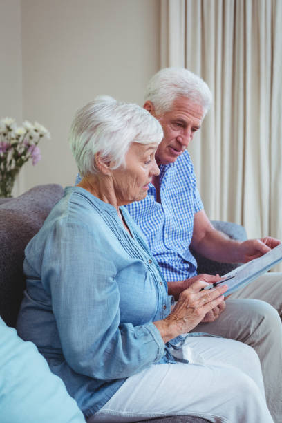 istock Senior couple calculating bills 673729394