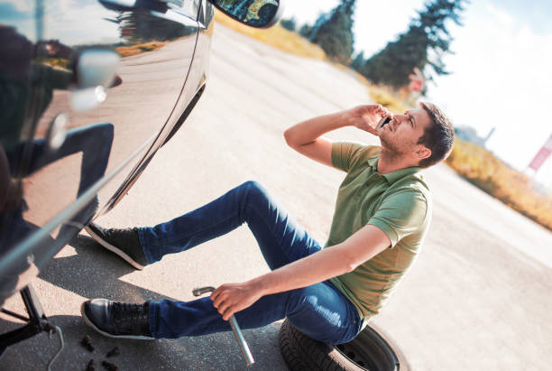 istock Problem with a car. A broken car on the road. Changing wheel 673738456