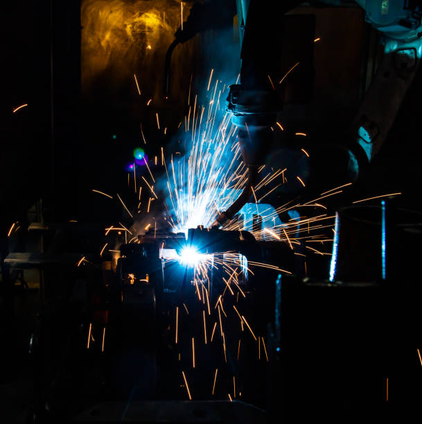 istock Welding robots movement in a car factory 673738640