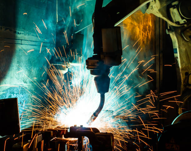 istock Welding robots movement in a car factory 673738796