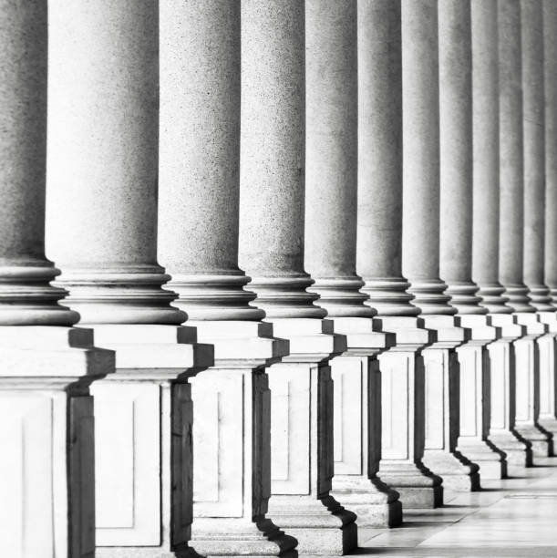 istock Black and white row of classical columns, background copy space 673741630