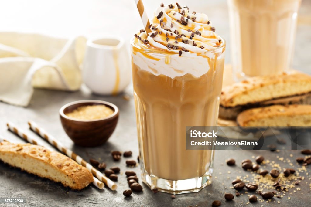 Iced caramel latte coffee in a tall glass Iced caramel latte coffee in a tall glass with syrup and whipped cream Coffee - Drink Stock Photo