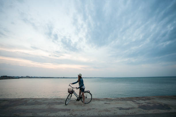 istock girl on bicycle at the sea 673745108
