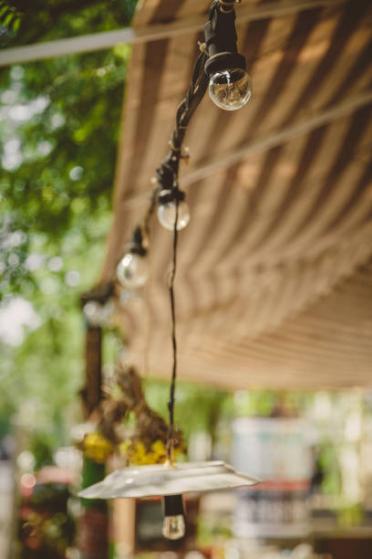 istock Decoration, outdoor retro vintage string lights hanging in a line. Lighting decor. 673747616