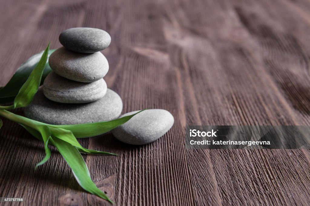 Zen Bamboo and boulder on the timber Boulder - Rock Stock Photo