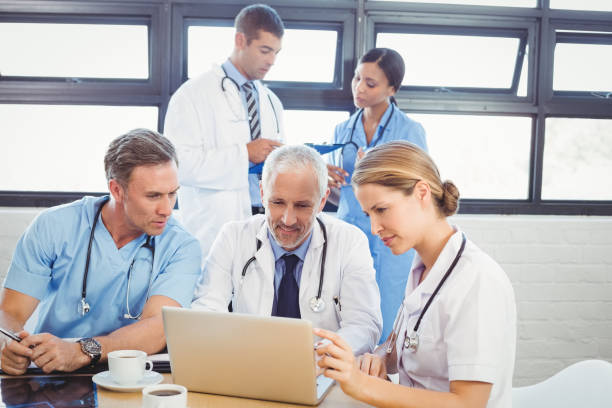 istock Medical team using laptop in conference room 673761910