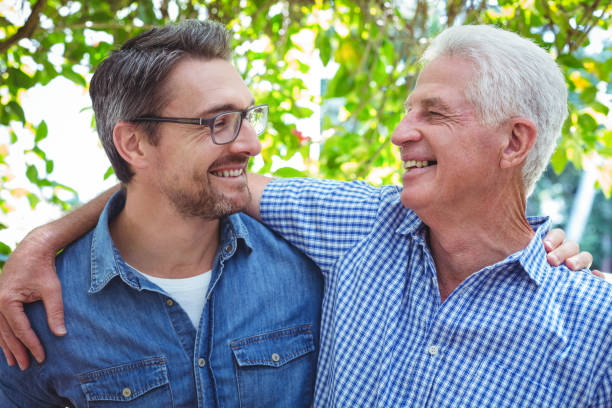 istock Cheerful father and son with arm around 673765090