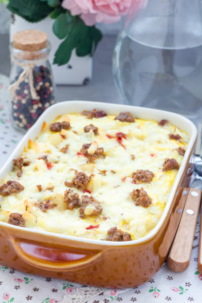 istock Egg casserole with potatoes, sausage and pepper, in baking dish, vertical 673765936