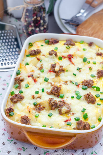 istock Egg casserole with potatoes, sausage and pepper, in baking dish, vertical 673765984