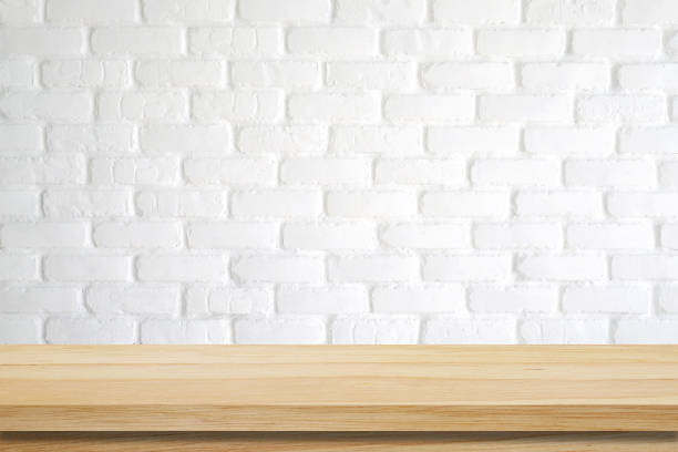 istock Empty wooden table over white brick wall background, template, product display montage 673771082