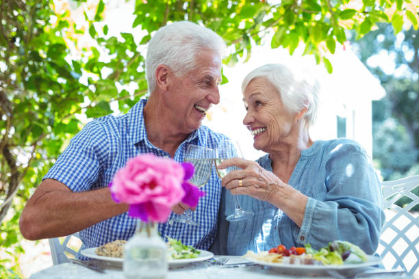 istock Senior couple toasting white wine 673771262