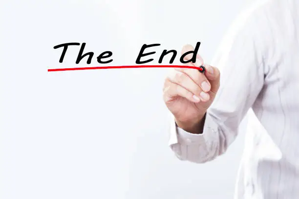 Photo of Businessman hand writing the end, Business concept.