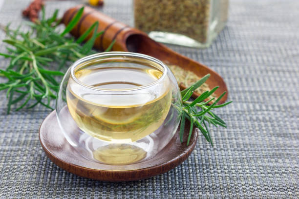 istock Herbal rosemary tea in a glass cup on oriental background, horizontal, copy space 673777344