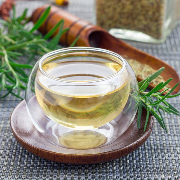 istock Herbal rosemary tea in a glass cup on oriental background, square format 673777346