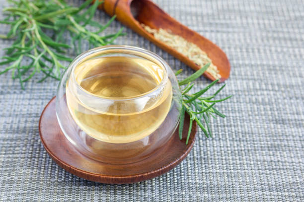 istock Herbal rosemary tea in a glass cup on oriental background, horizontal, copy space 673777358