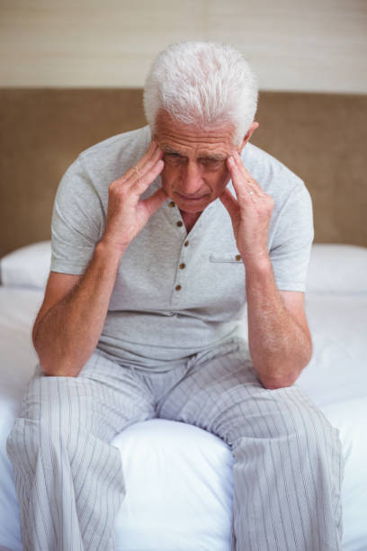 istock Tensed senior man with head in hands 673777570