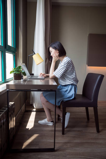 istock Young beautiful girl using laptop at home 673781138