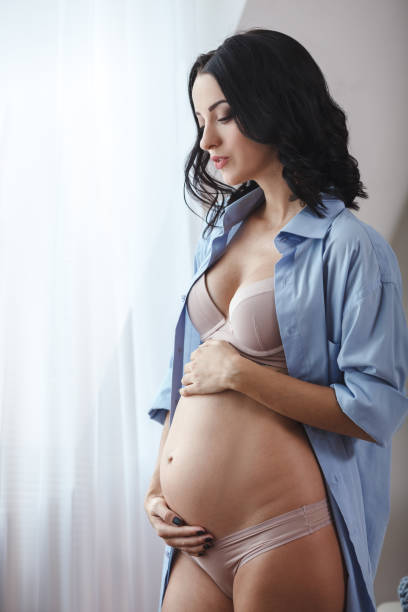 istock Pregnant woman touching belly 673784300