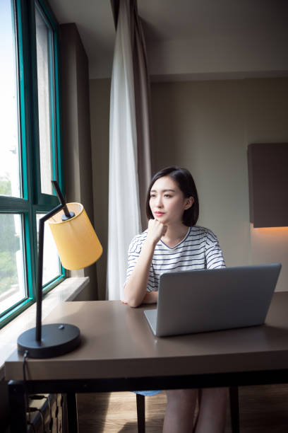 istock Young beautiful girl using laptop at home 673784580