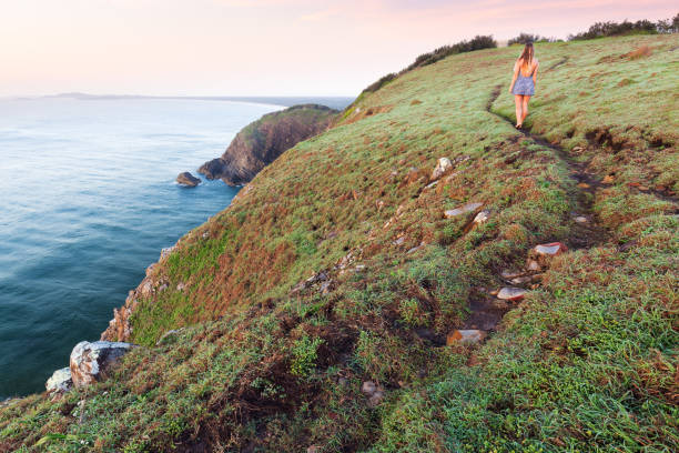 Girl Walks on Coastal Trail stock photo