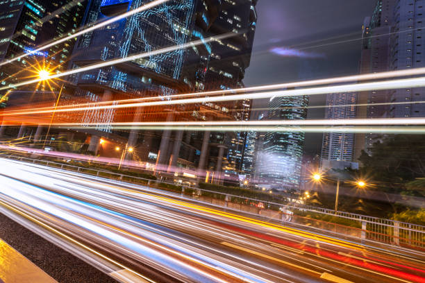 istock light trails on city street with cityscape 673788042