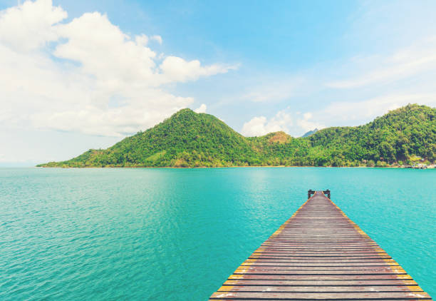 istock old wood bridge pier on Beautiful sea 673791080