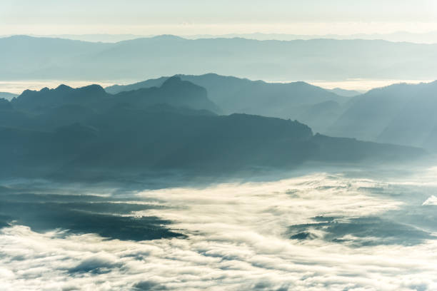 istock Mountain layer in morning sun ray and winter fog. 673795662
