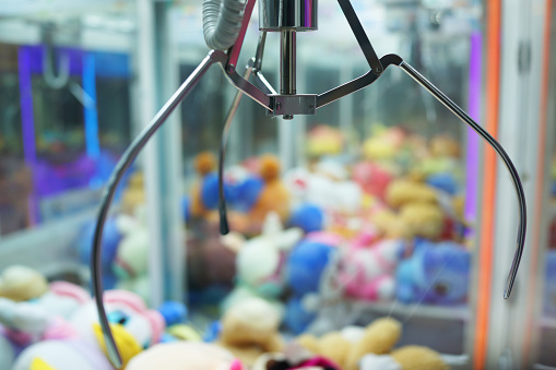 The doll sold in coin operating machine by using joystick to control the clamp to pull the doll up.