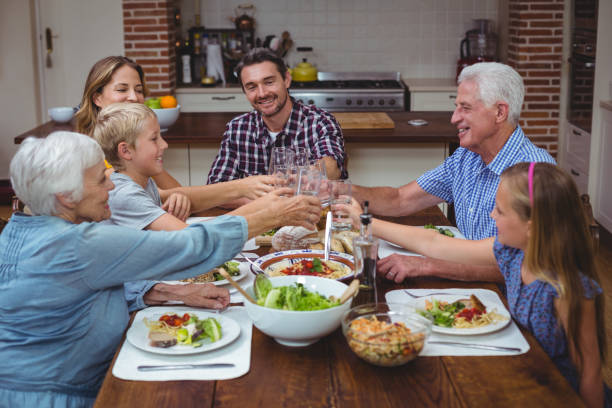 istock Multi generation family toasting drink while celebrating thanksgiving 673801758